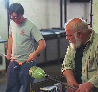Hugh Irwin and son working a piece at Hickory Street Hot Glass, placing the punty.
